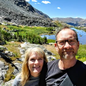 Jen Schwem stands with her husband as they take a selfie on a hike in Colorado. 