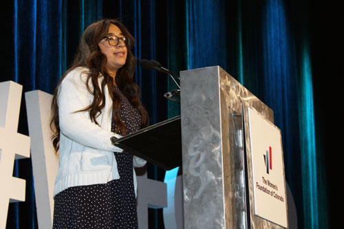 Natalie speaks at podium at the 2021 Annual Luncheon