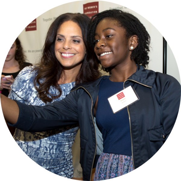 Soledad O'Brien takes a selfie with a young Black woman at the 2015 Annual Luncheon