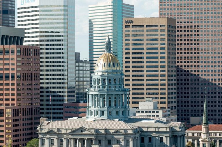 Colorado state capitol surrounded by high-rise buildings