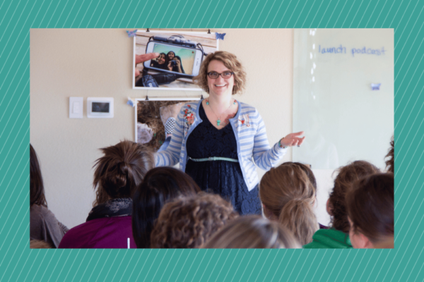 A white woman with glasses speaks to a group of people on overcoming imposter syndrome.