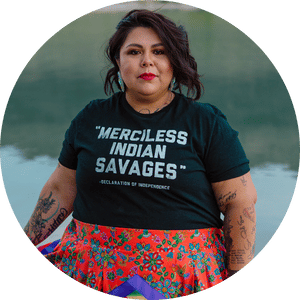 Headshot of Trennie Burch wearing a shirt that says "MERCILESS INDIAN SAVAGES" - DECLARATION OF INDEPENDENCE