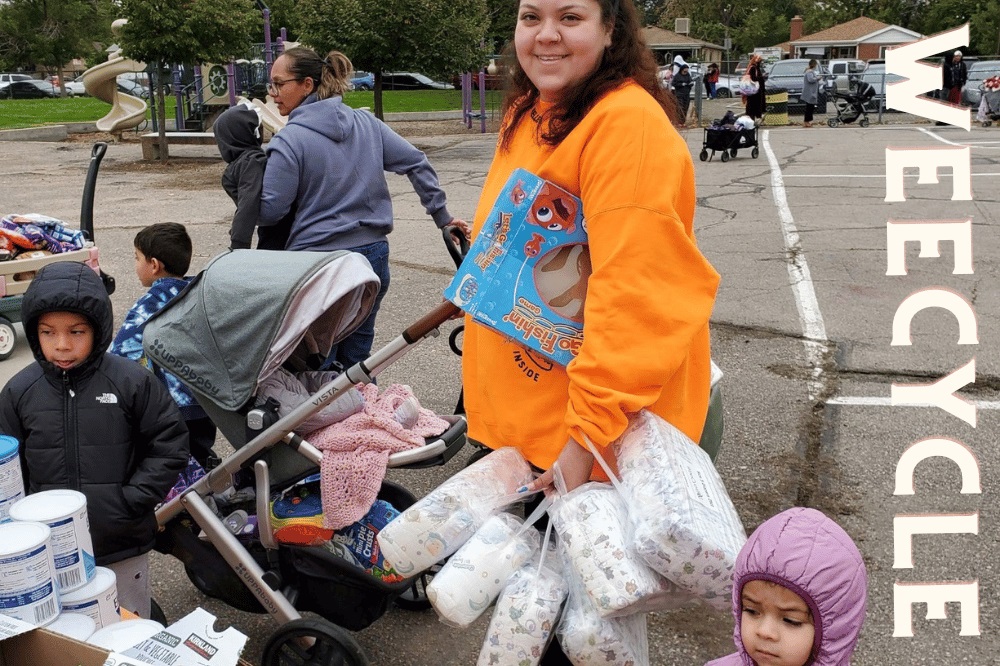 A woman and her two children at a diaper distribution bank.